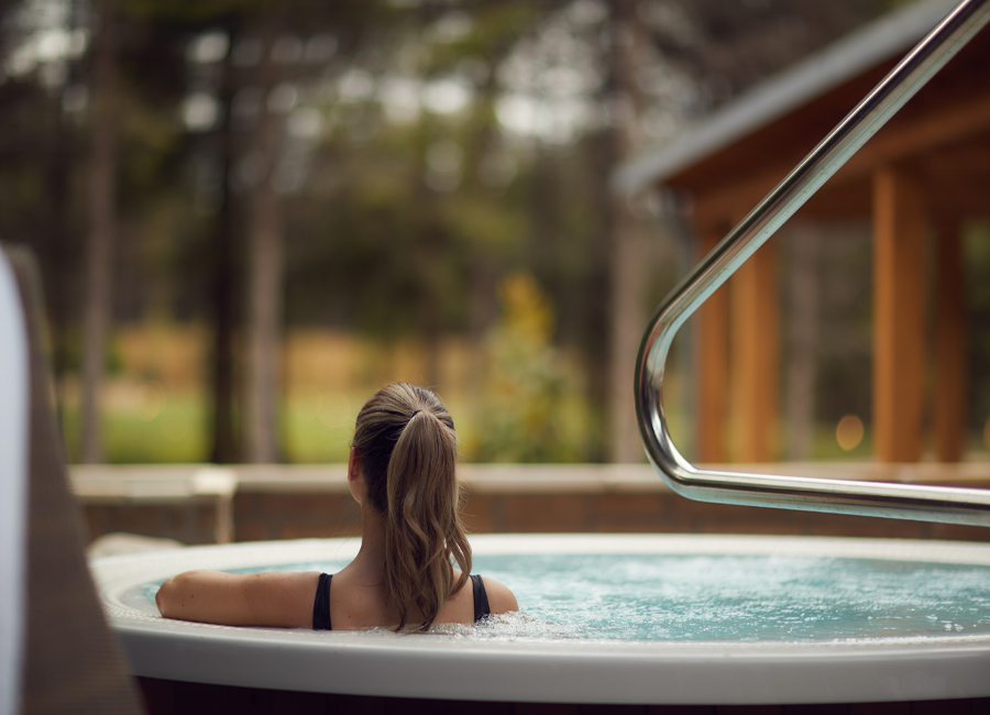 Woman in the Nordic Sauna looking out at the forest.