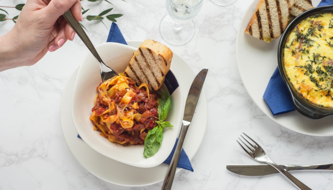 Pasta dishes served with beverages.