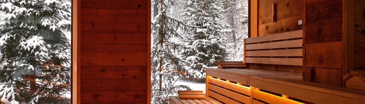 wooden sauna with window and view of snow 