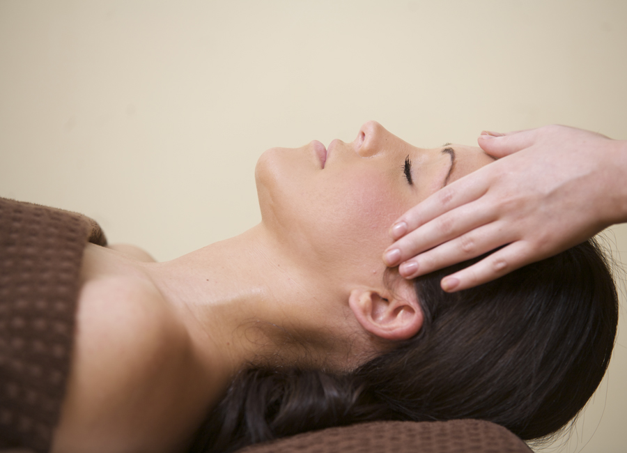 women with eye closed receiving treatment 