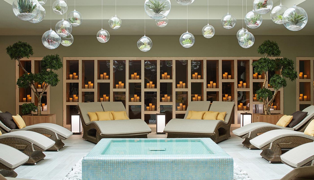 Contoured lounge chairs surrounding a decorative water feature.