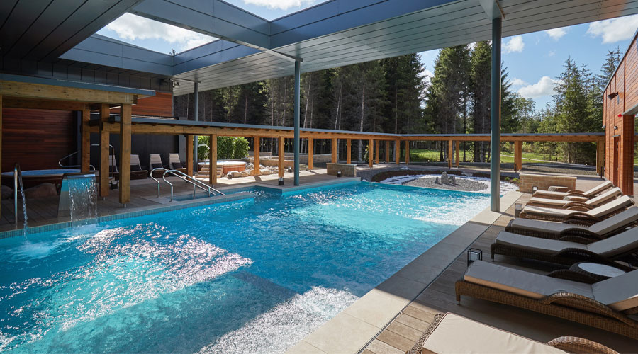 Outdoor pool surrounded by sun loungers 