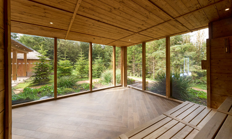 Inside the Nordic Sauna with views out to the surrounding forest.