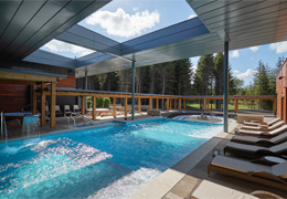 Outdoor pool surrounded by sun loungers 