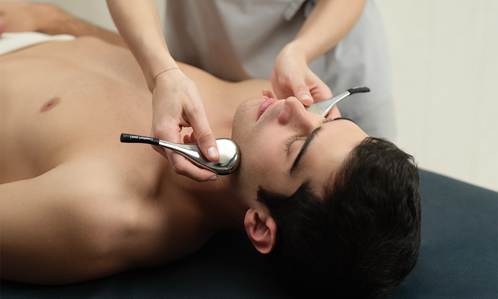 Woman having a facial with little brushes. 