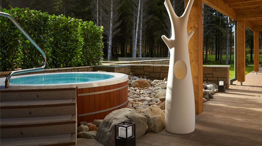 outdoor hot tub with view of forest