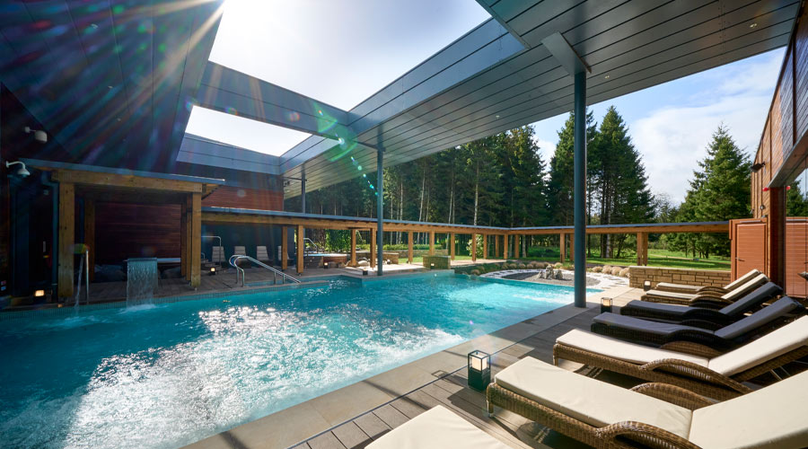 Bubbling outdoor pool surrounded by sun loungers.