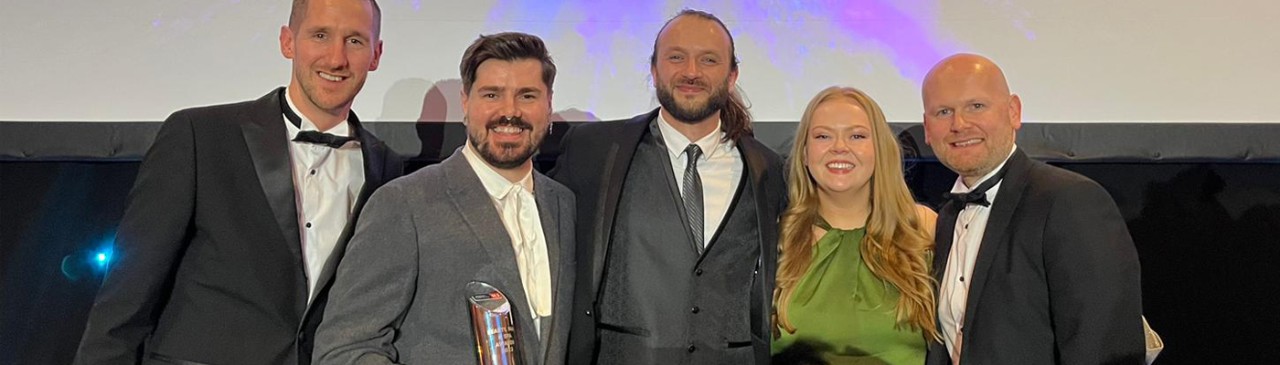 Group of people holding a Proffessional Beauty Award.