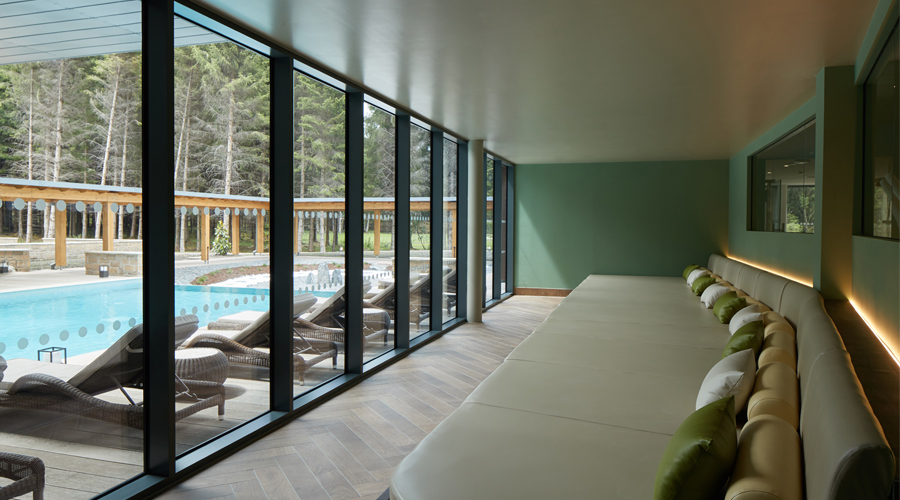 relax room with large sofa and views of outdoor pool