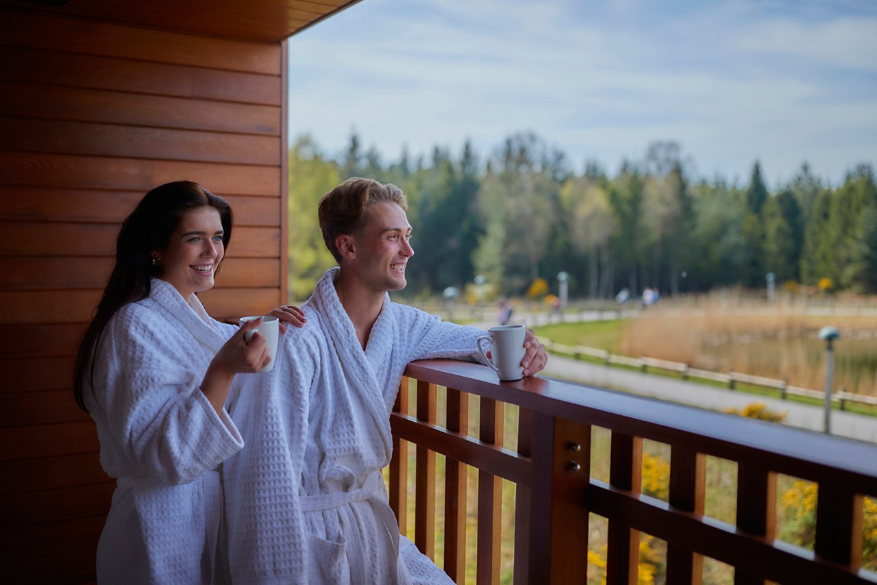 couple on the apartment balcony looking at the view