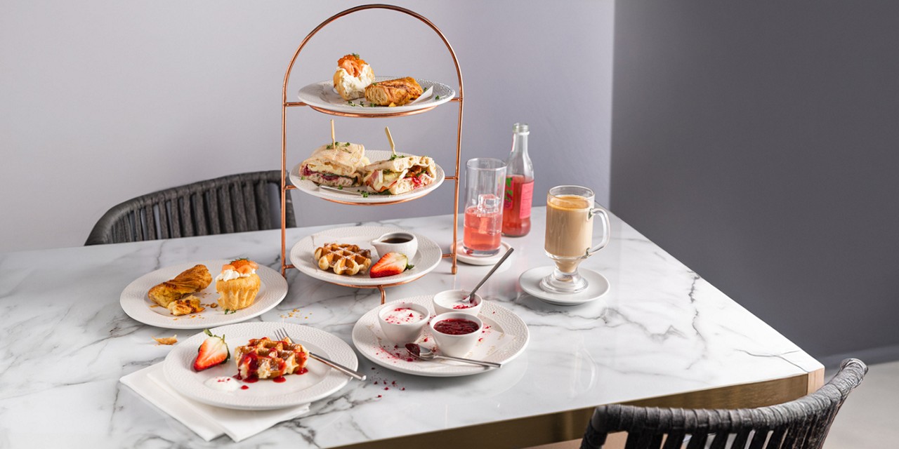 Stacked brunch served with a pot of tea.