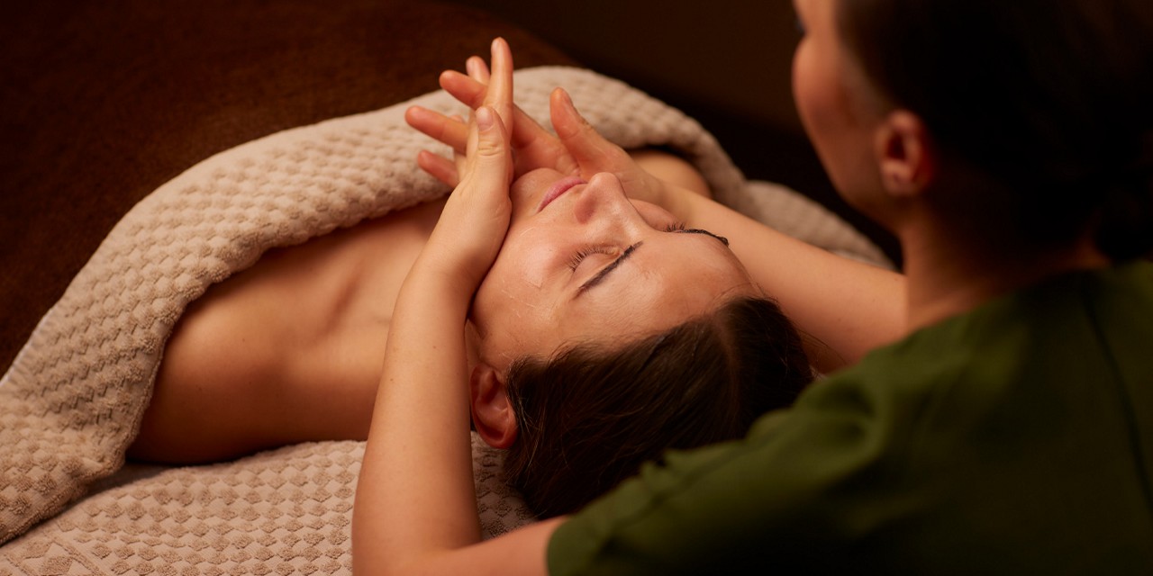 Woman having a relaxing facial treatment.