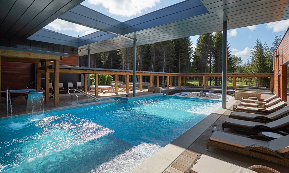 Outdoor pool surrounded by sun loungers 