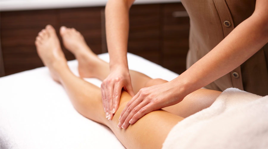 women receiving body massage on the leg