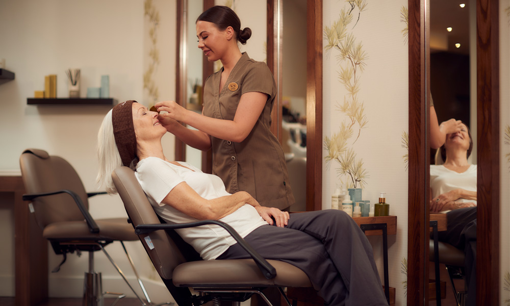 therapist performing eye treatment in express area