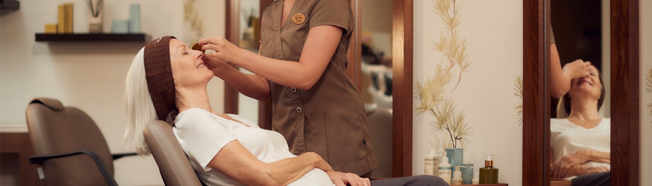therapist performing eye treatment in express area