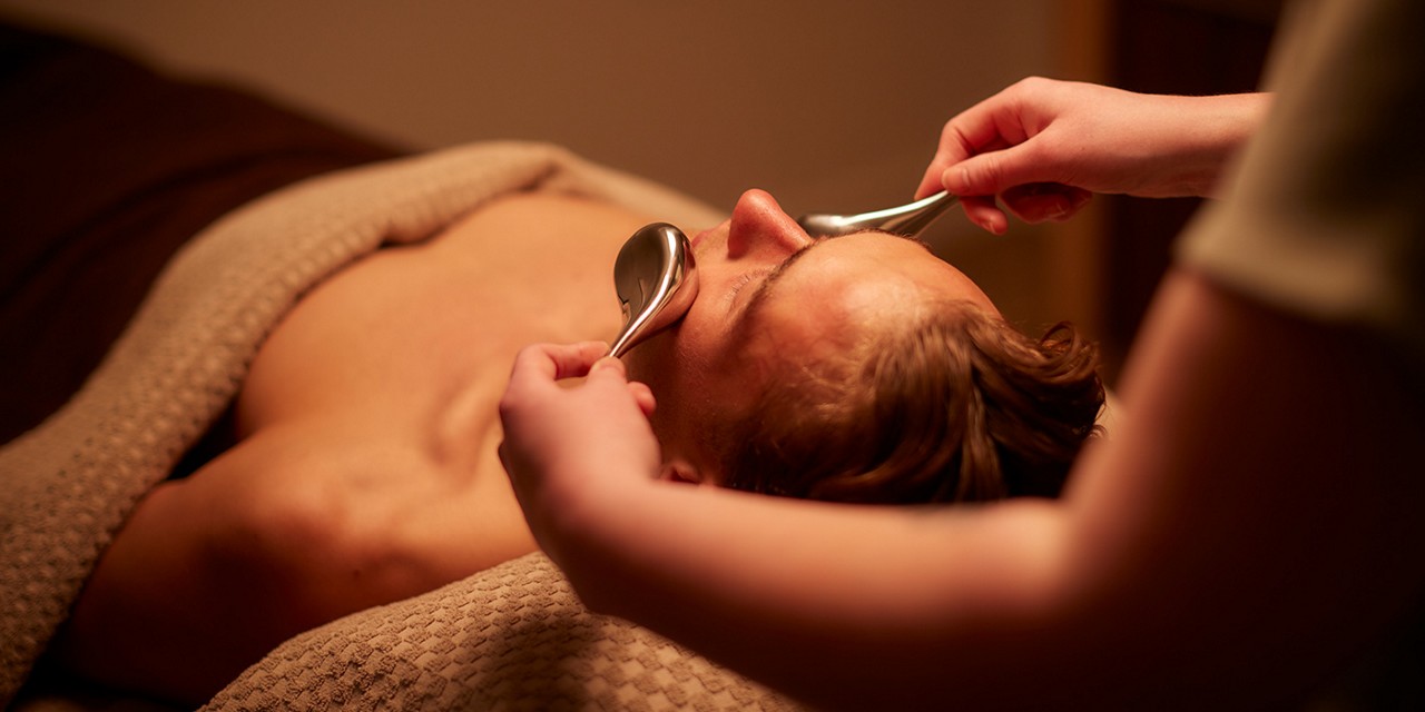 Man having a facial with smooth metal devices.