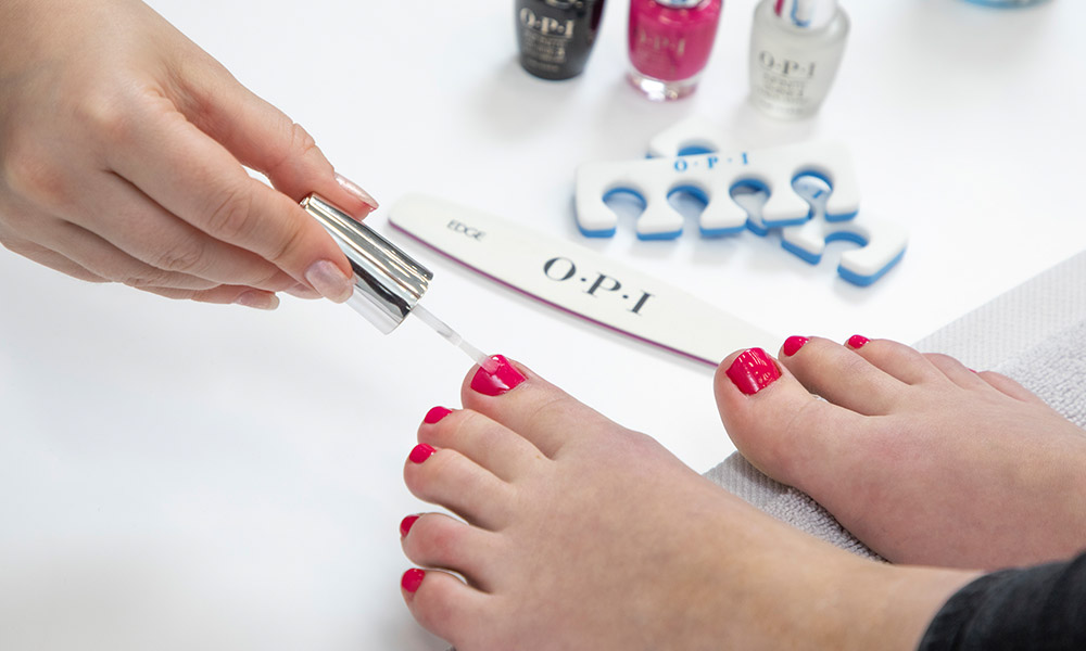 feet with nails being painted