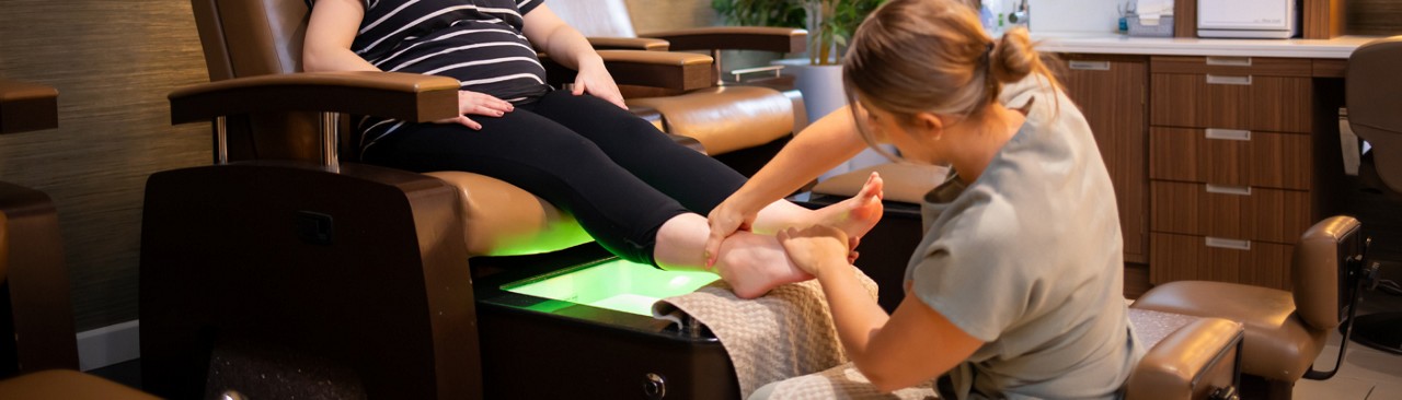 Oil being dropped onto freshly painted nails.