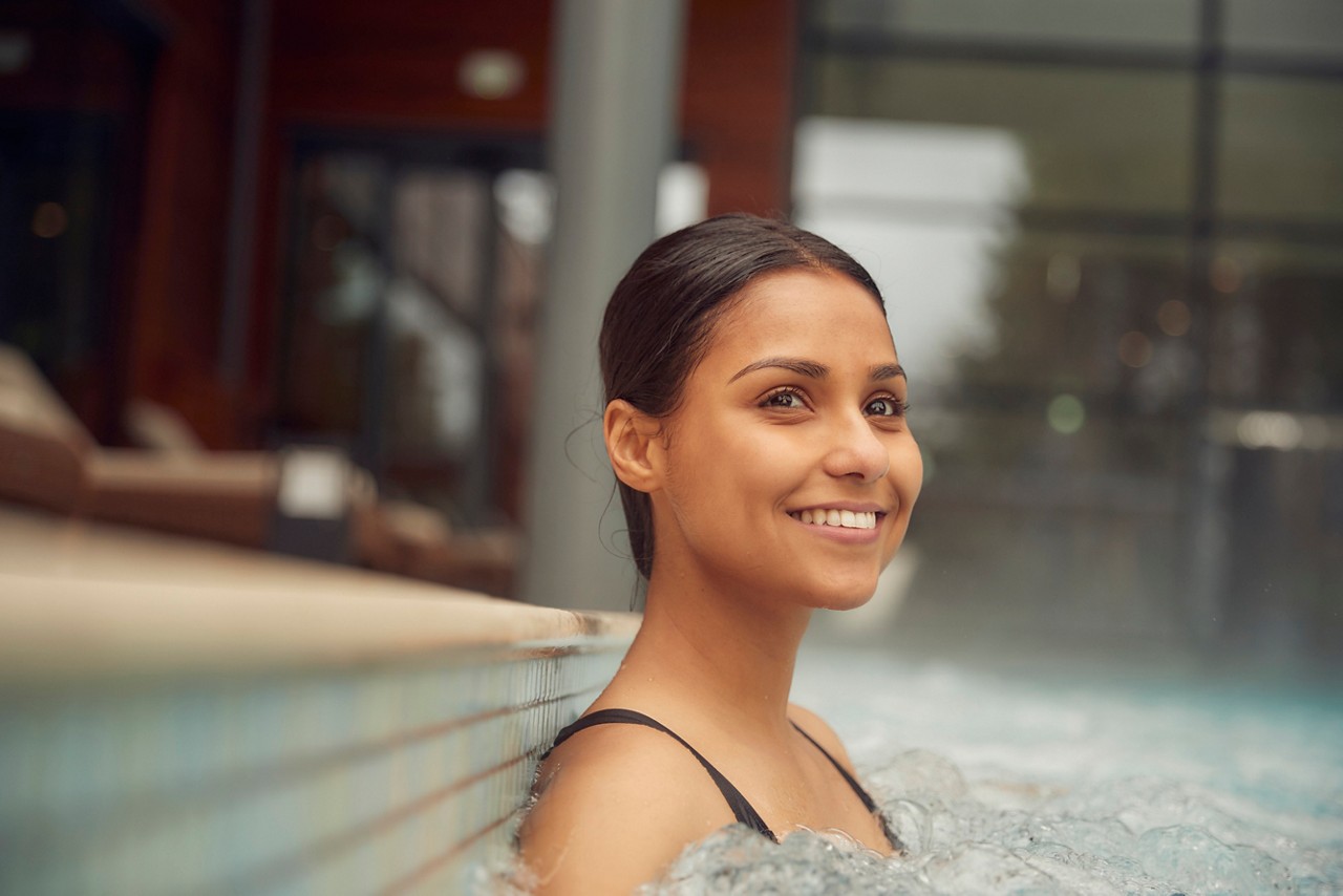 Woman soaking in an Outdoor Pool.