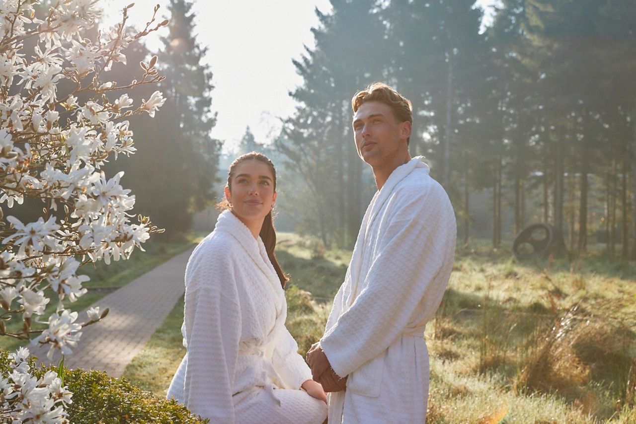 couple in robes by blossom