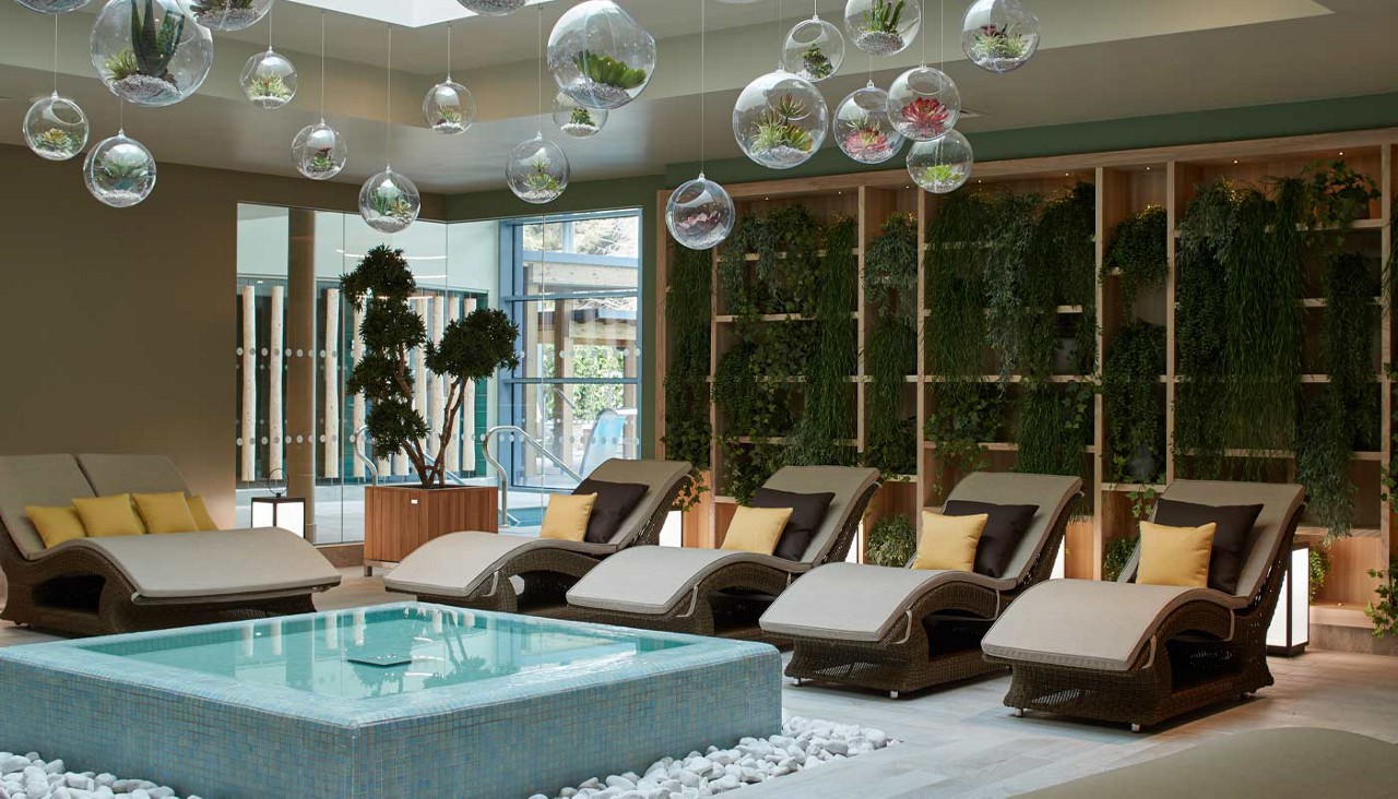 Contoured lounge chairs surrounding a decorative water feature.