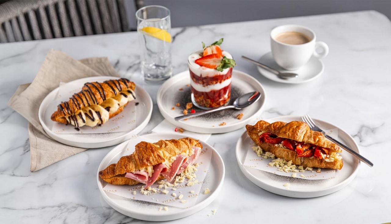 Breakfast items including sweet and savoury croissants and a granola pot.