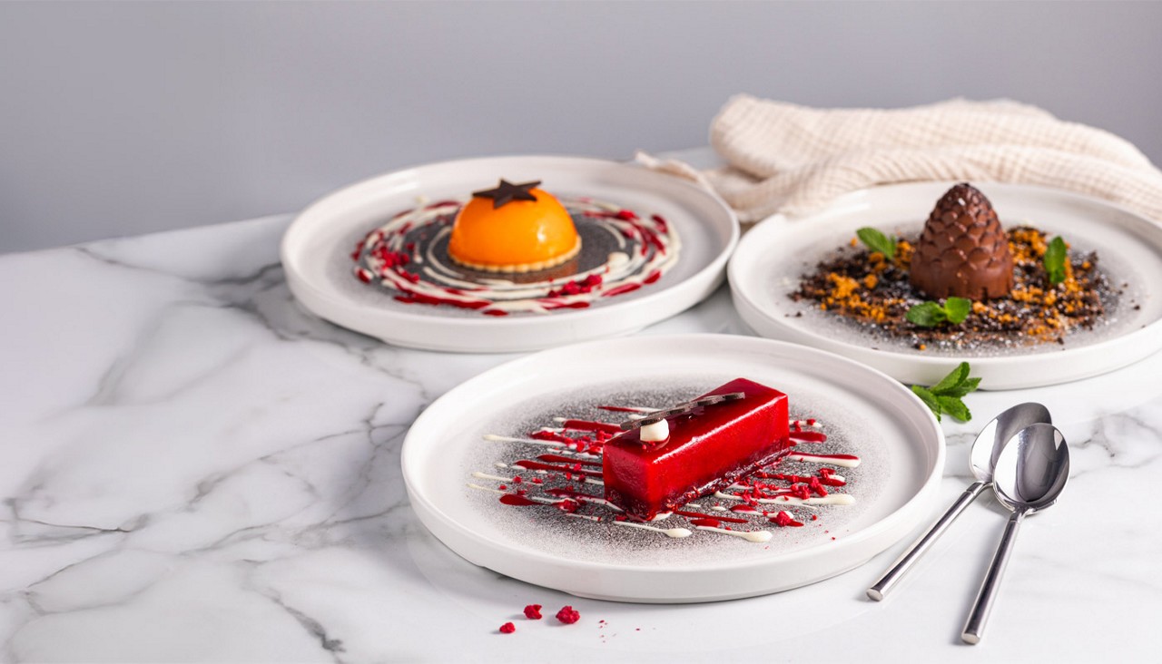 Selection of desserts including chocolate mouse and fruit tarts.