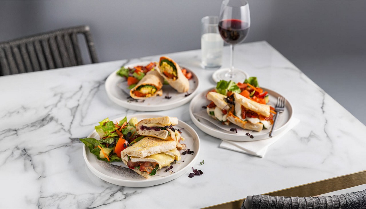Wraps and stuffed focaccia served with salad.