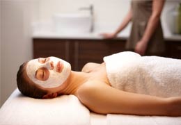 Lady on treatment bed with face mask on
